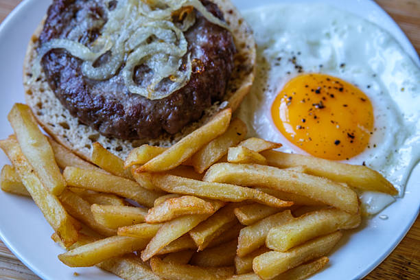 London UK June 27 2025, Homemade Ham Or Beefburger With Onions Frites And A Fried Egg