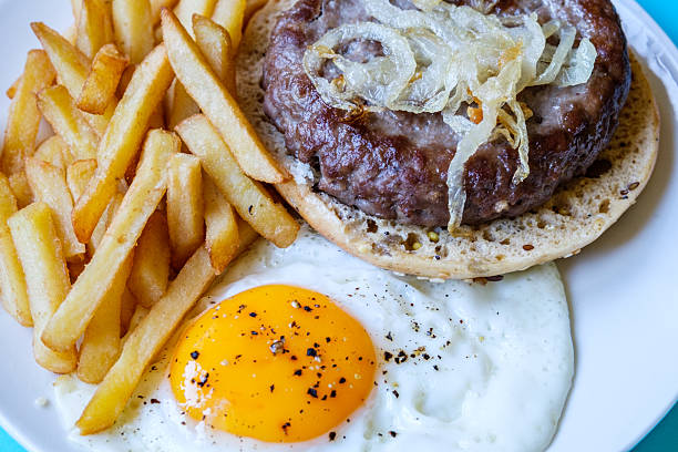 London UK June 27 2025, Homemade Ham Or Beefburger With Onions Frites And A Fried Egg