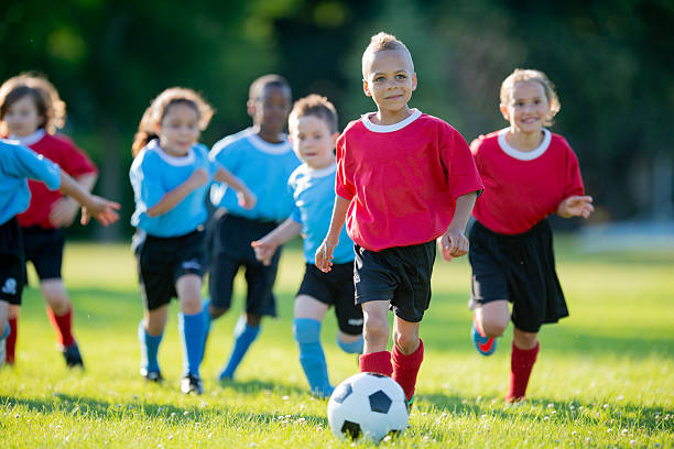 istock Children Playing Soccer on a Sunny Field During a Fun Game 2222471041