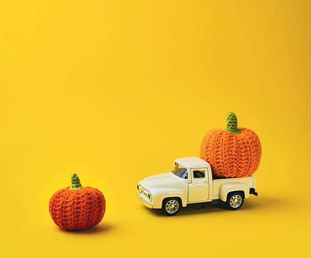 istock White truck is carrying two orange pumpkins 2222472456