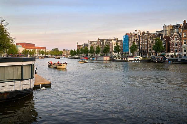 Tourist boats sightseeing on the Amstel River. Amsterdam, Netherlands. September 17, 2024.