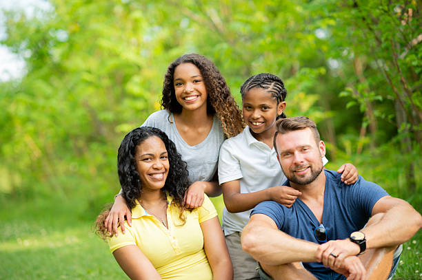 istock Happy Family Posing Outdoors in a Green Park Setting 2222473958