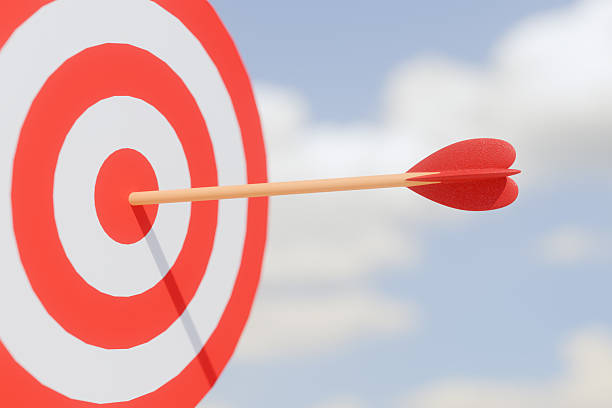 istock Arrow hitting the bullseye on a red and white target against a blue sky. 3d rendering 2222474363