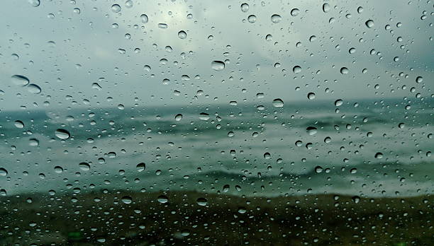 istock Raindrops on a car window during winter with sea view. 2222474593