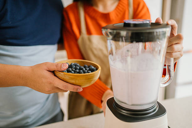 istock Asian couple preparing smoothies with blueberry at home 2222474834