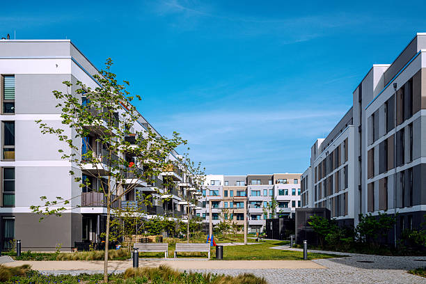 istock Modern Residential Apartments Complex with Green Courtyard Under Blue Sky 2222475962
