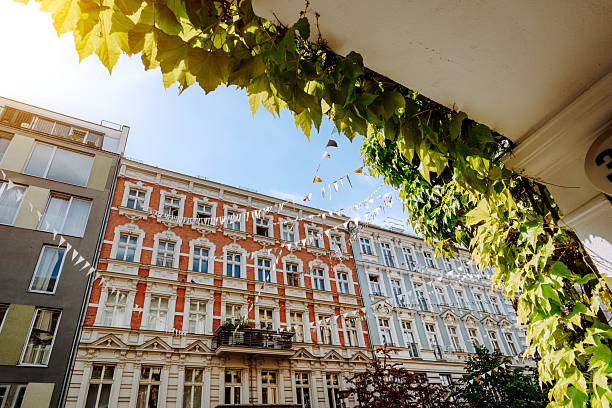 Beautiful architecture view showcasing historic buildings and greenery in a sunlit neighborhood in Berlin, Germany. A scene exuding charm and tranquil urban vibes during a pleasant summer day.