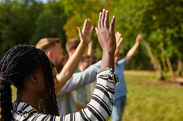 istock Diverse audience raising hands to ask questions at educational event in summer park 2222477404