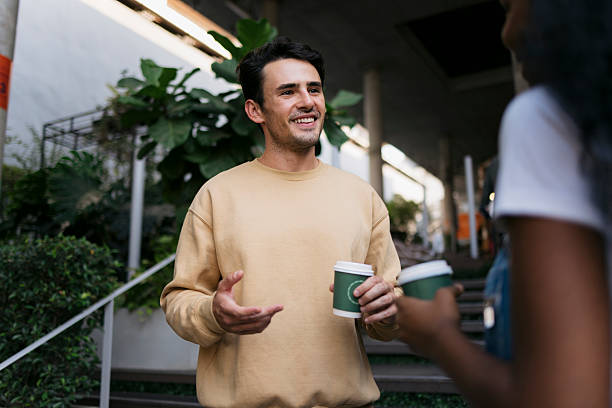 Friends standing out a coffee shop and talking