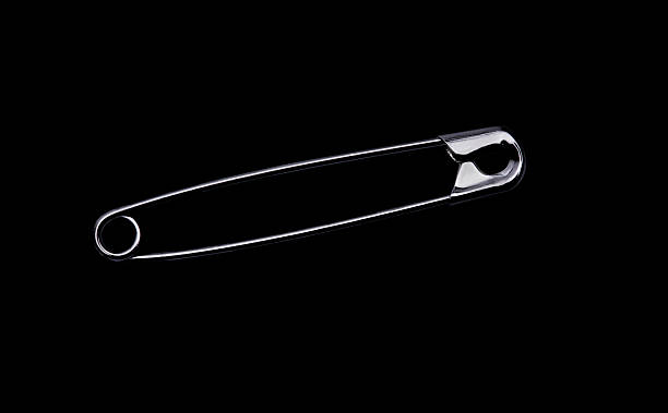 istock Freed safety pin in front of black background 2222480670