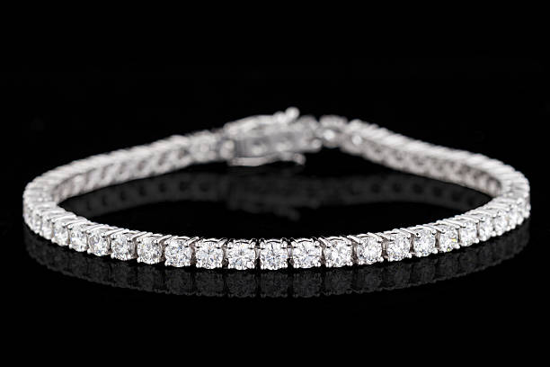 istock bracelet silver, gold with stone diamonds on black background 2222482548
