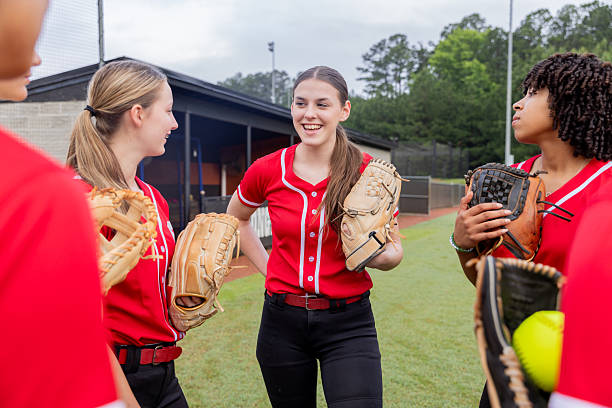 istock Softball players discuss game during huddle on high school softball field 2222484369