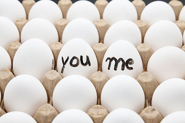 istock white chicken eggs in the cardboard egg tray with a words write YOU ME on it 2222484662