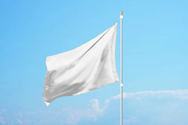 istock Empty white flag in the wind on clear blue sky, ideal for promotional design, customization or national identity mockups 2222484792