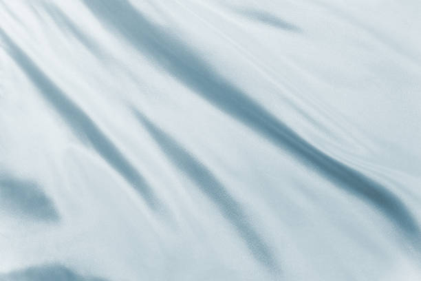 istock Soft white silk waving in natural light, ideal for elegant textures, minimalist backgrounds, or product mockups in high-end design 2222484802