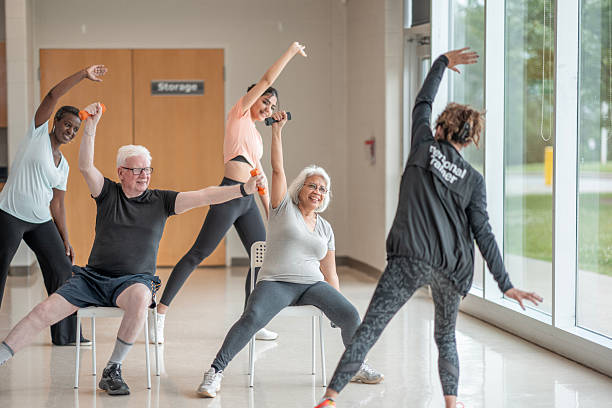 istock Group Exercise Session for Seniors With Personal Trainer in Wellness Center 2222486200