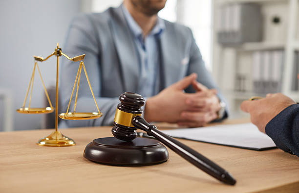 Close up of photo of a male lawyer working on his workplace in office on a wooden table. stock photo