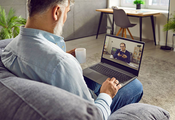 istock Rear view of businessman talking with colleague using laptop webcam 2222490984