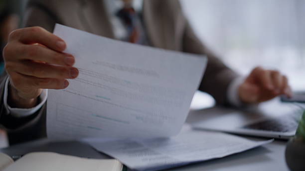 istock Hands typing computer keyboard at office closeup. Smiling lawyer looking papers 2222494068