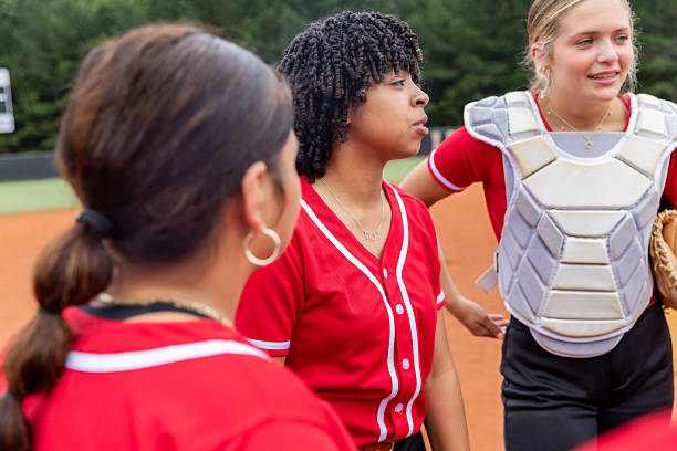 istock Diverse high school softball players huddle to discuss play during game 2222496070
