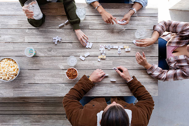 istock Friends Playing Dominoes Outdoors on a Sunny Day 2222498189