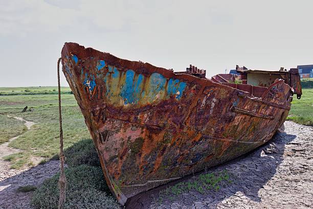 an old rusty ship washed up on the shore of the Barents Sea on the Kola Peninsula
