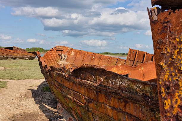 istock A rusted, decaying ship sits on a sandy shore beneath a cloudy sky. 2222500473