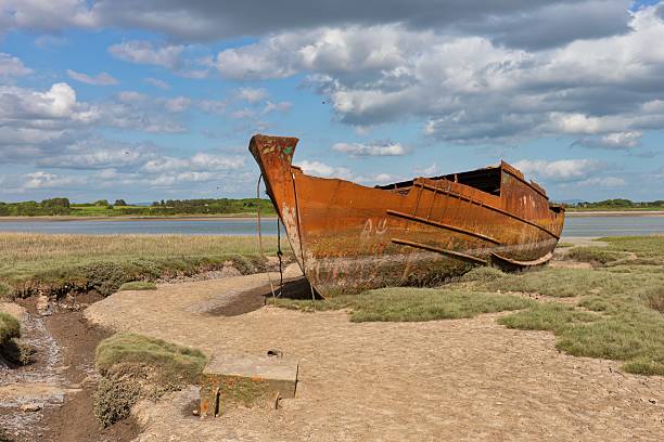 View of an abandoned ship beached at Llannerch-y-Mor Wharf near Mostyn Docks North Wales, UK.  There are no people in the photograph