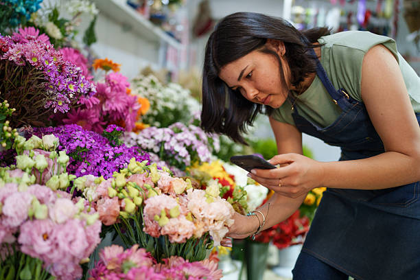 istock Florist using mobile phone at the flower shop 2222501466