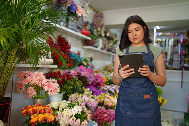 istock Florist using digital tablet at the flower shop 2222501555