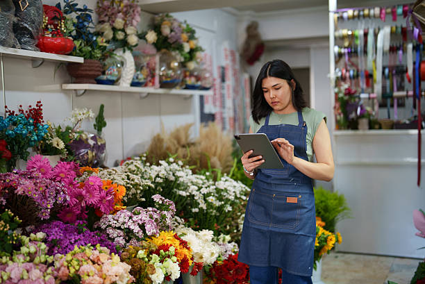 istock Florist using digital tablet at the flower shop 2222502255