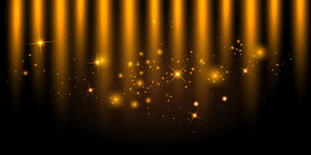 istock Golden sparkles and glowing starbursts on a dark background with soft vertical light beams. This abstract festive backdrop creates a luxurious and celebratory atmosphere, perfect for award ceremonies, holiday events, or magical designs. 2222506443