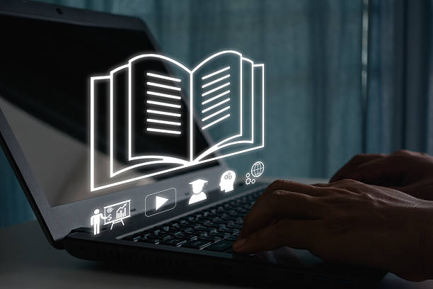 istock Person using laptop for online education and e-learning with digital book icon, studying course, virtual class, and training concept for modern learning and business technology skill development. 2222512940