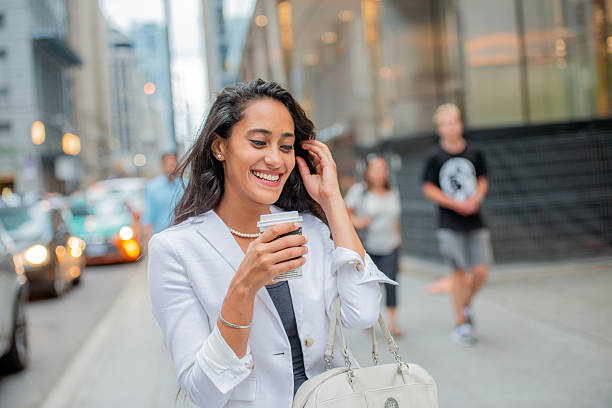 istock Confident Businesswoman Enjoying Coffee While Strolling Through City Streets 2222513131