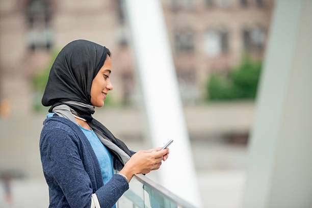 istock Young Woman Using Smartphone Outdoors in Urban Environment 2222513260
