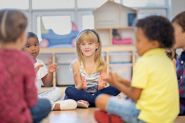 istock Children Sitting Together in a Classroom Playing and Smiling 2222514039