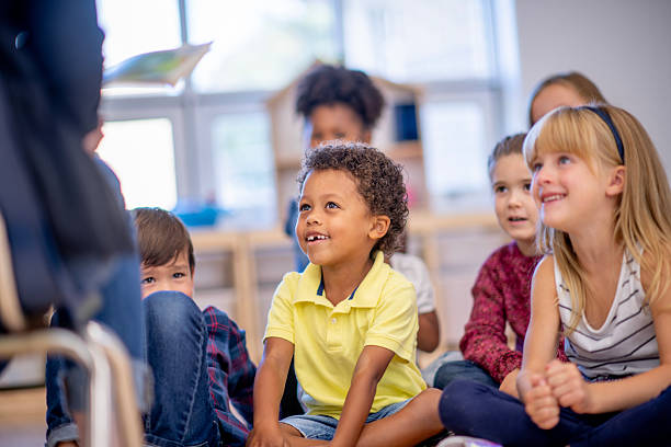 istock Joyful Children Sitting Attentively in a Bright Classroom Gathering 2222514165