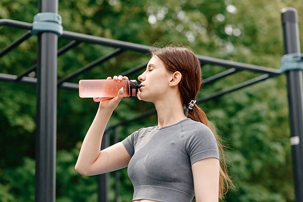 istock young woman does sport exercises outdoors in summer 2222515825