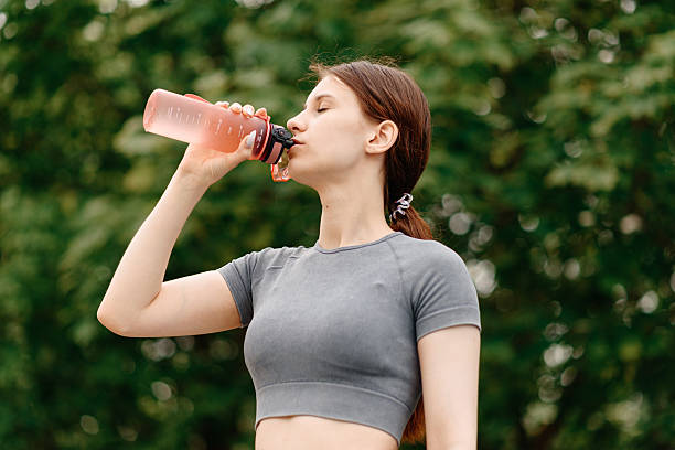 istock young woman does sport exercises outdoors in summer 2222515827