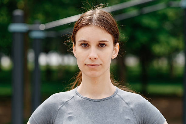 istock young woman does sport exercises outdoors in summer 2222515839