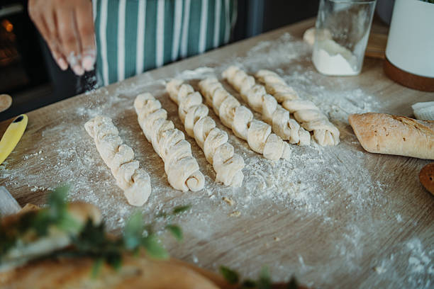 istock Young caucasian woman making bread dough in her kitchen 2222516280