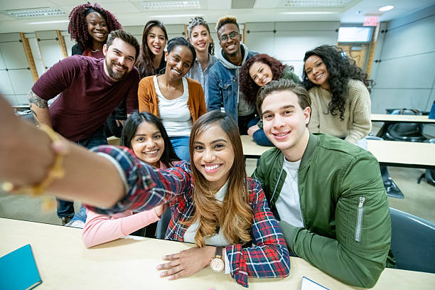 istock Group of Students Smiling and Taking a Selfie in a University Classroom 2222516541
