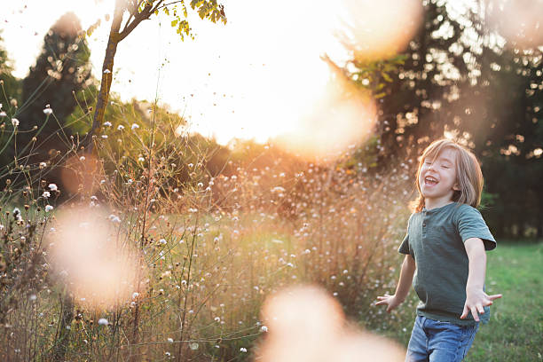 istock Joyful child playing among wildflowers 2222519541