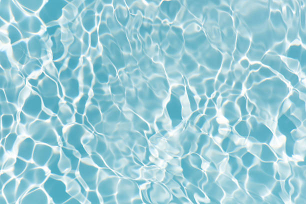 istock Blue water with ripples on the surface. Defocus blurred transparent blue colored clear calm water surface texture with splashes and bubbles. Water waves with shining pattern texture background. 2222523161