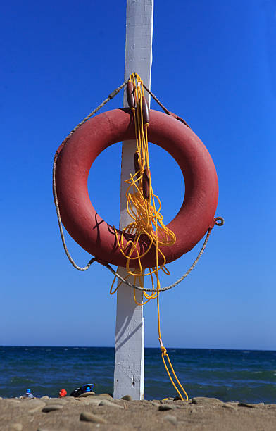 istock Lifebuoy on a pole on a sea beach 2222523529
