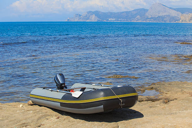 istock Rubber inflatable boat with motor on the seashore 2222523716