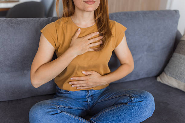 istock Woman practicing deep breathing exercise for stress relief at home 2222526751