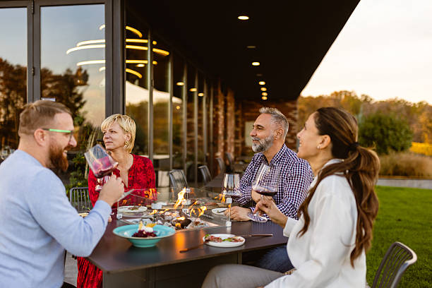 istock Friends Enjoying Outdoor Dinner at Sunset 2222529862