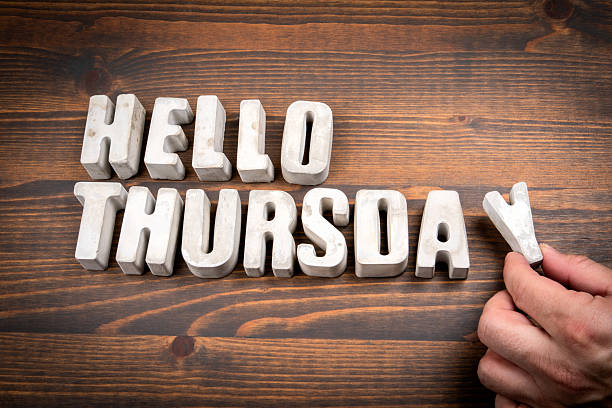 istock Hello Thursday. Concrete alphabet letters and coffee mug on dark wooden texture background 2222530120