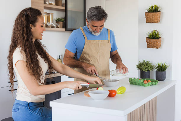 istock Father and daughter preparing breakfast together in modern kitchen 2222530388